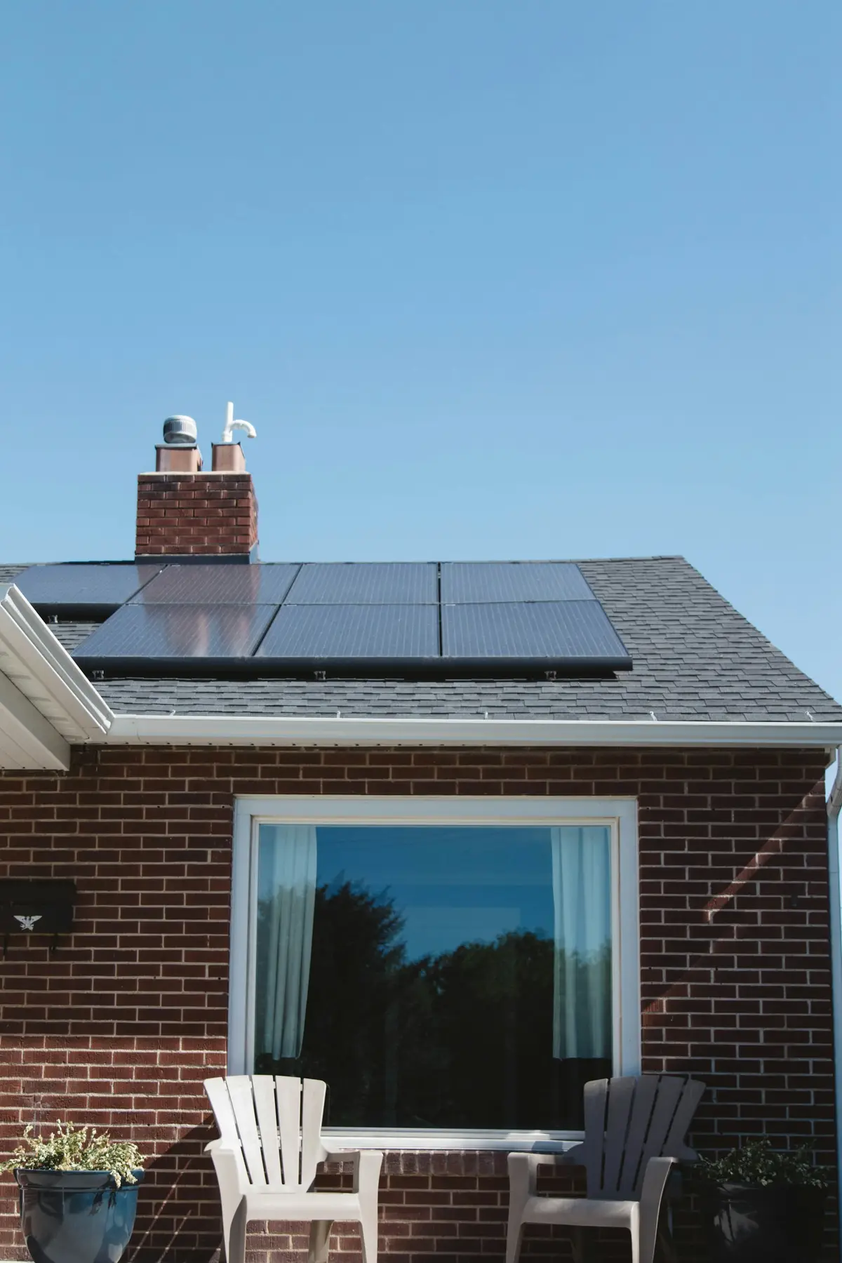 Two-story brick home with a rooftop solar panel array